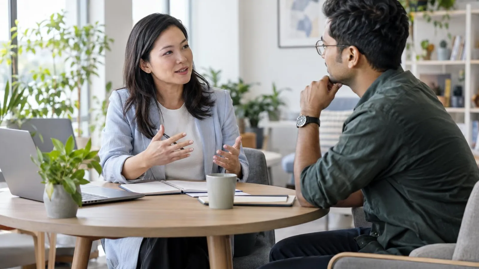 A career coach and a client in conversation in a bright office