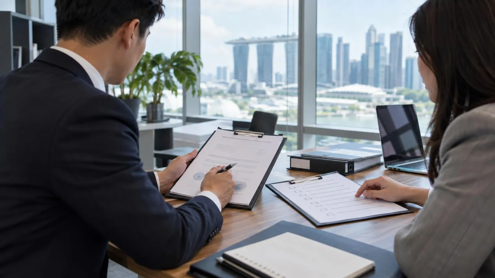 An auditor reviewing quality-management documents and a certificate during an ISO audit in a Singapore office