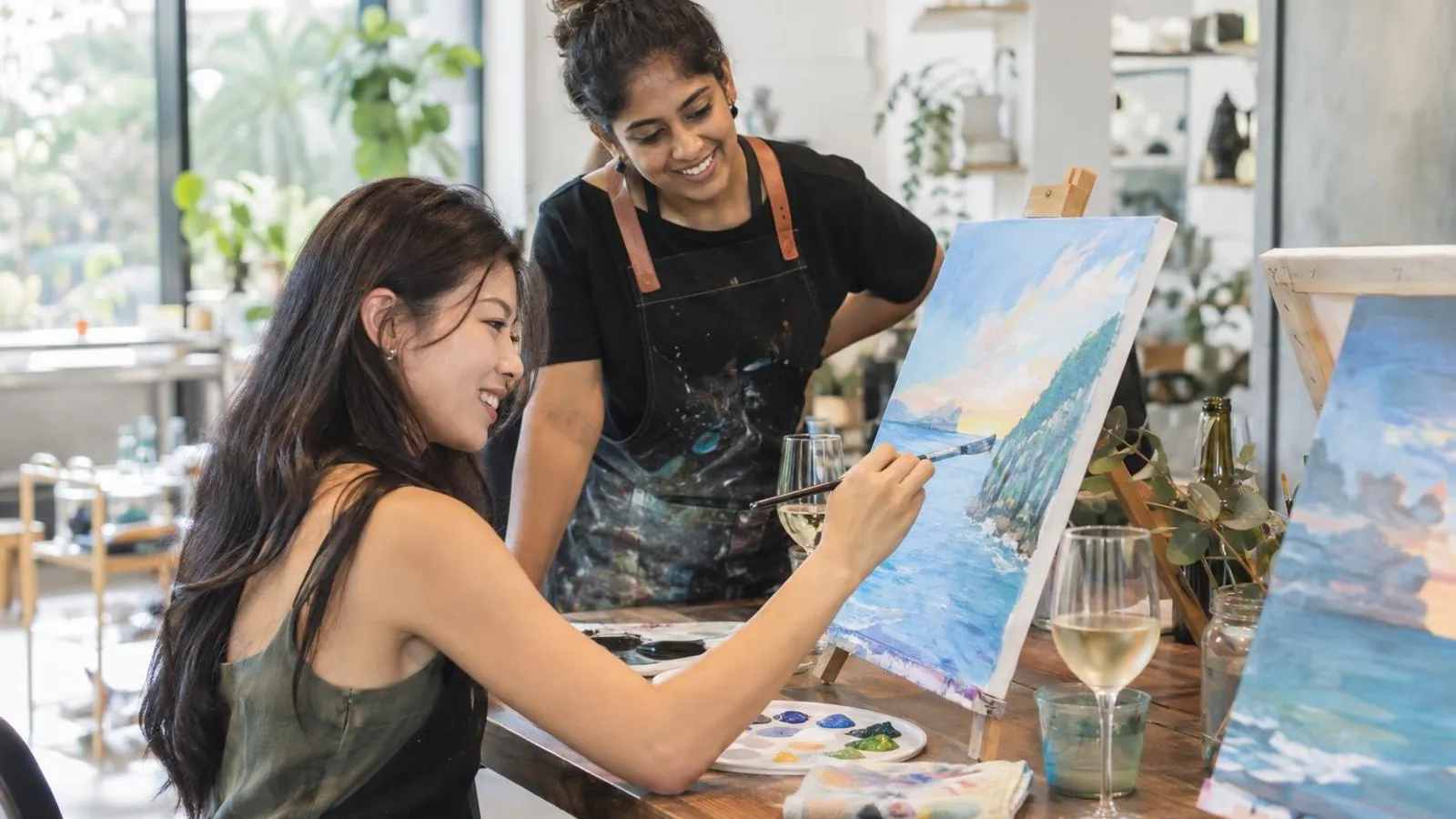 Paint and Sip Workshops: a customer and a provider in a bright, modern setting