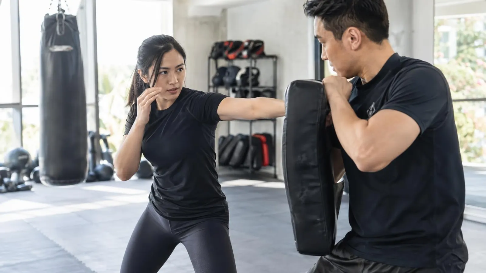 Self-Defence and Krav Maga Classes: a customer and a provider in a bright, modern setting