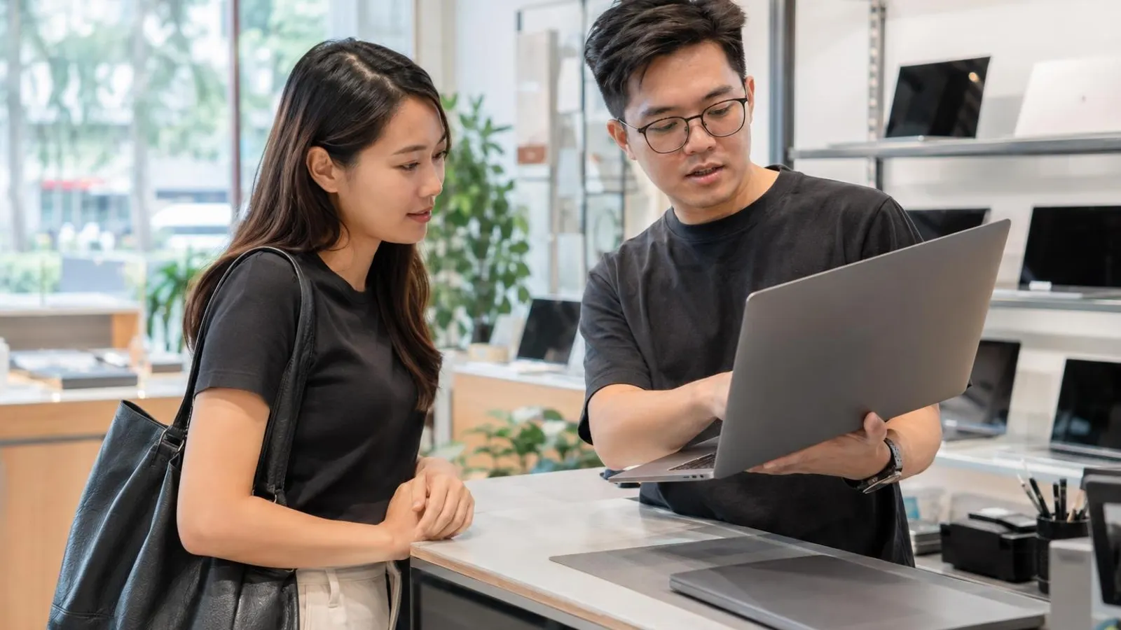 Places to Sell Your Used Laptop: a customer and a provider in a bright, modern setting