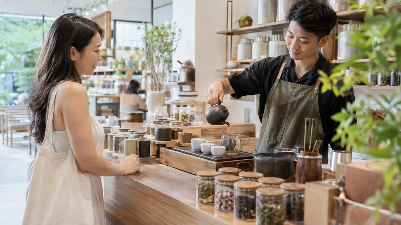 Tea Shops: a customer and a provider in a bright, modern setting